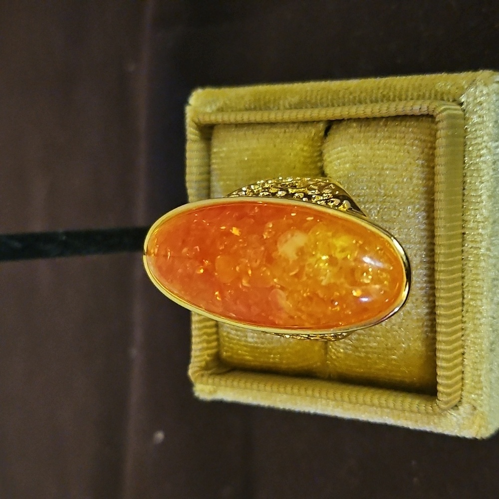 Gold tone ring with orange stone like